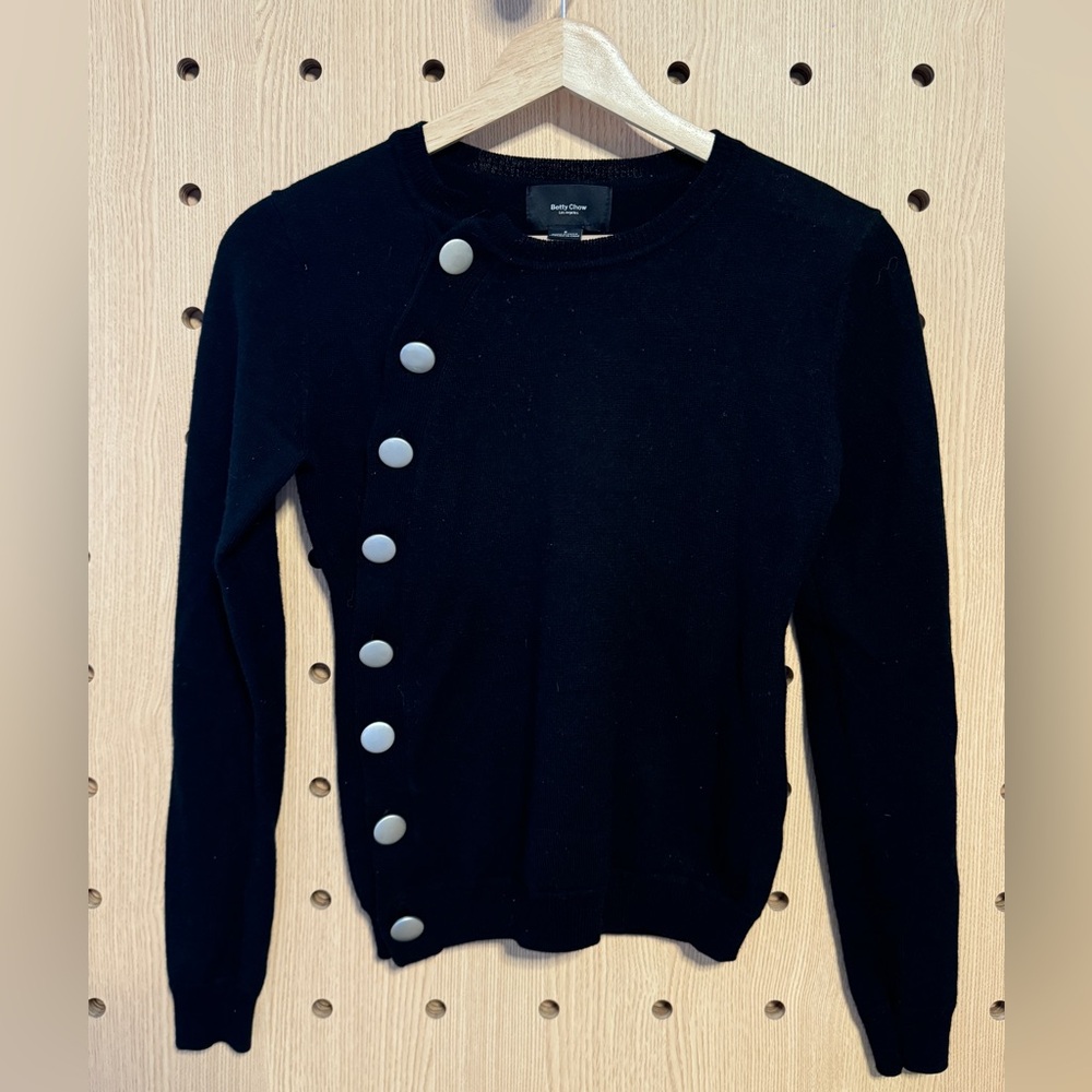 black cardigan sweater with silver buttons along the side